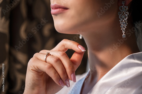 Gentle female hands of the bride with a gold wedding ring on the ring finger
