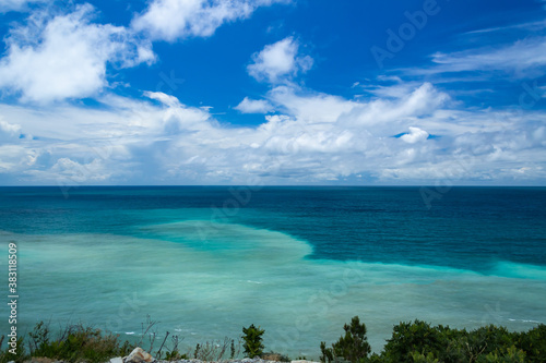 blue sea against the cloud sky  the view from the cliff. The water is multicolored