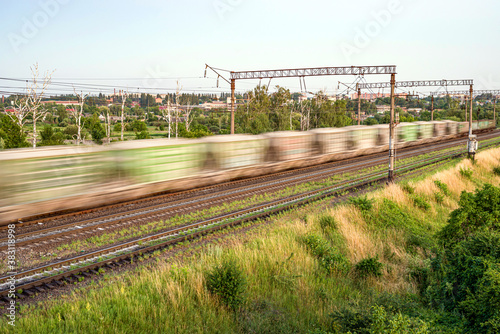 Train with different freight cars that are blurred at high speed