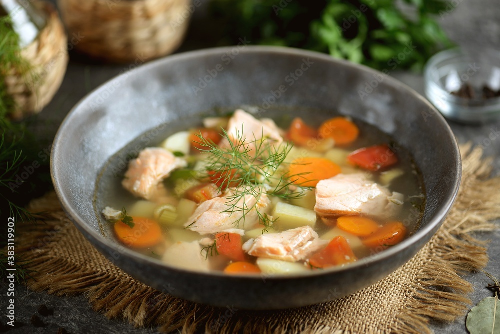 Vegetable soup with salmon, potatoes, onions and carrots. Healthly food.