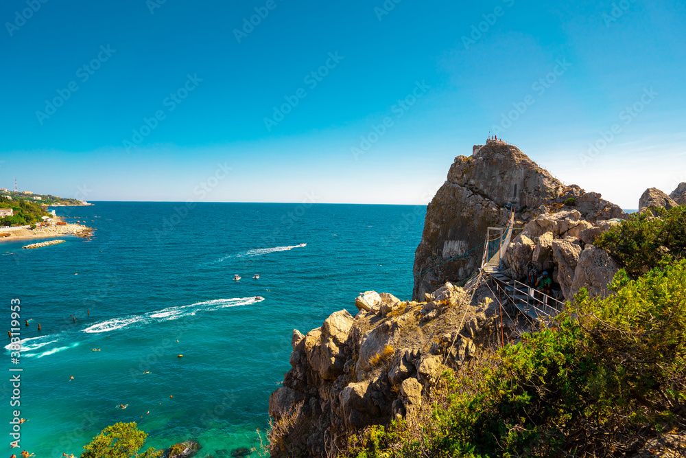 Panoramic view of the big rock in the sea with a stretched suspension bridge on the mountain in Crimea.
