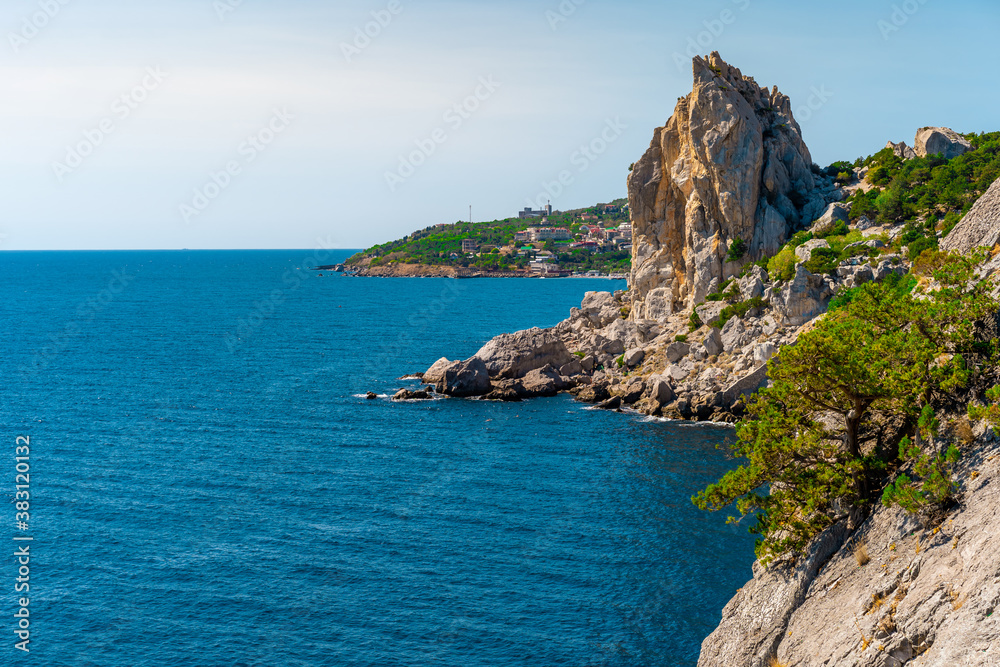 Panoramic seascape, calm azure sea and bright sun. View of the black sea coast of Crimea, Cape. Copy space. The concept of calm, silence and unity with nature
