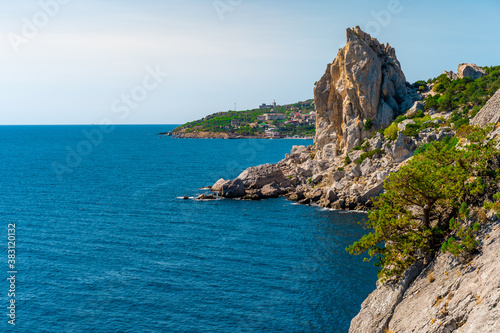 Panoramic seascape  calm azure sea and bright sun. View of the black sea coast of Crimea  Cape. Copy space. The concept of calm  silence and unity with nature