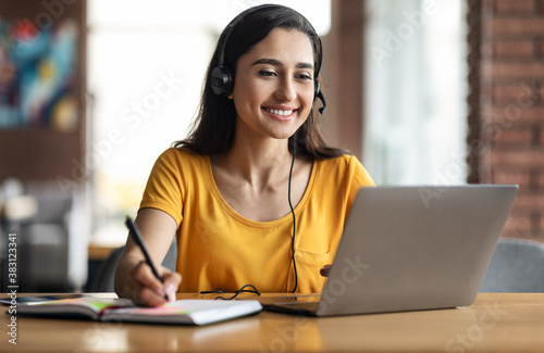 Happy young arab woman having educational course online photo
