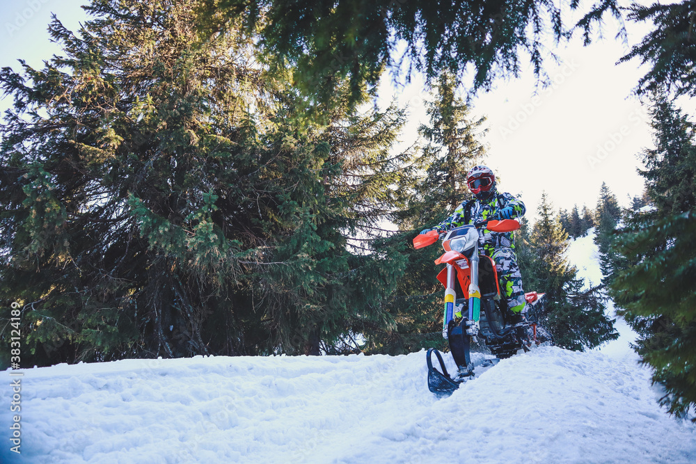 Snowbike rider in mountain valley in beautiful snow powder. Snowdirt bike with splashes and trail. Snowmobile winter sport riding Snowbike rider in mountain valley in beautiful snow powder. Snowdirt bike with splashes and trail. Snowmobile winter sport riding