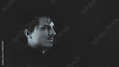 Profile view of young man in the dark. male portrait