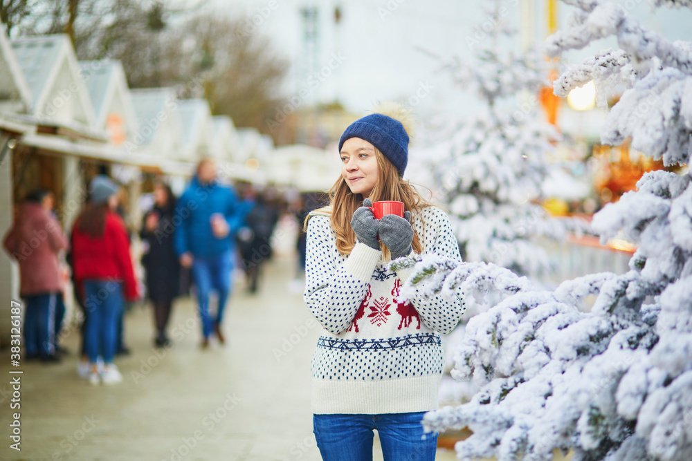 Happy young woman on Christmas market in Paris, France Happy young woman on Christmas market in Paris, France