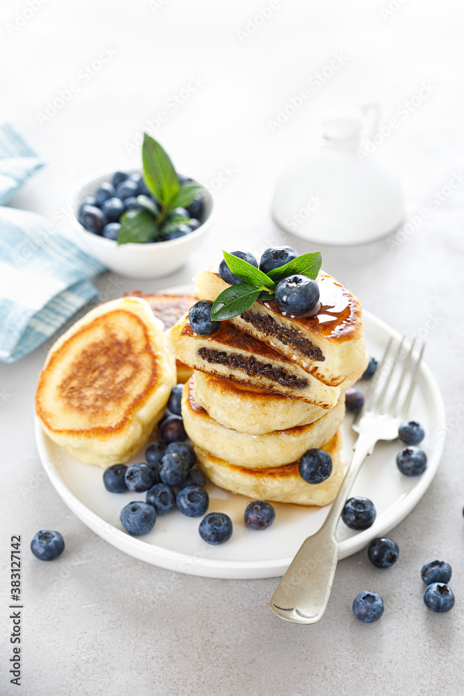 Fluffy souffle pancakes with chocolate filling and fresh blueberry for breakfast. Fluffy souffle pancakes with chocolate filling and fresh blueberry for breakfast.