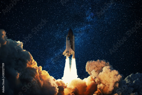 Fototapeta Naklejka Na Ścianę i Meble -  Rocket takes off in the starry sky. Spaceship begins the mission. Space shuttle taking off on a Planet Mars.