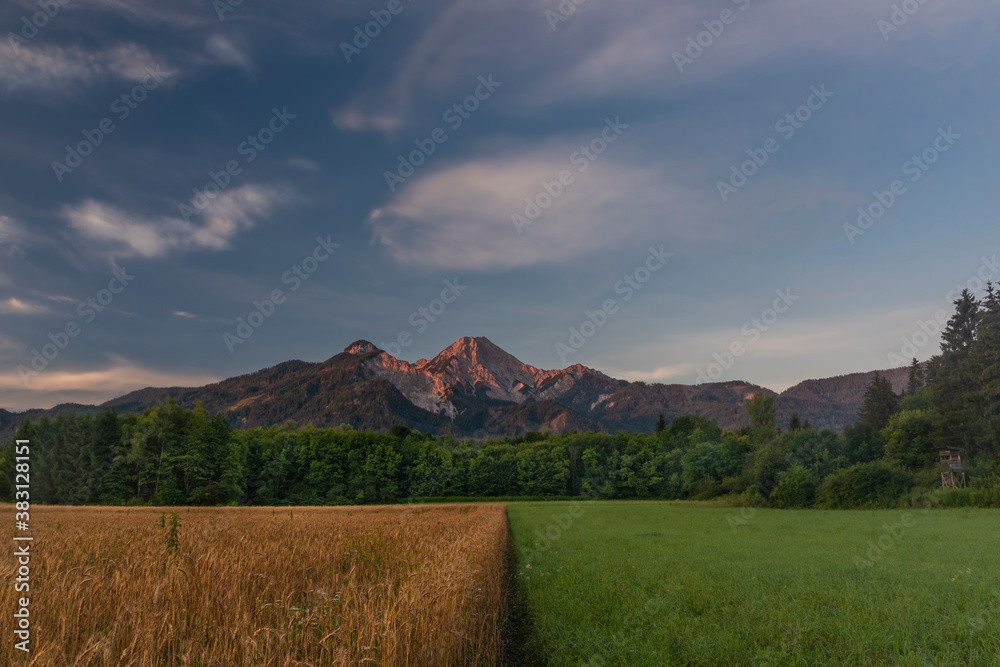 Fototapeta premium Red Mittagskogel hill in summer fresh blue sky morning