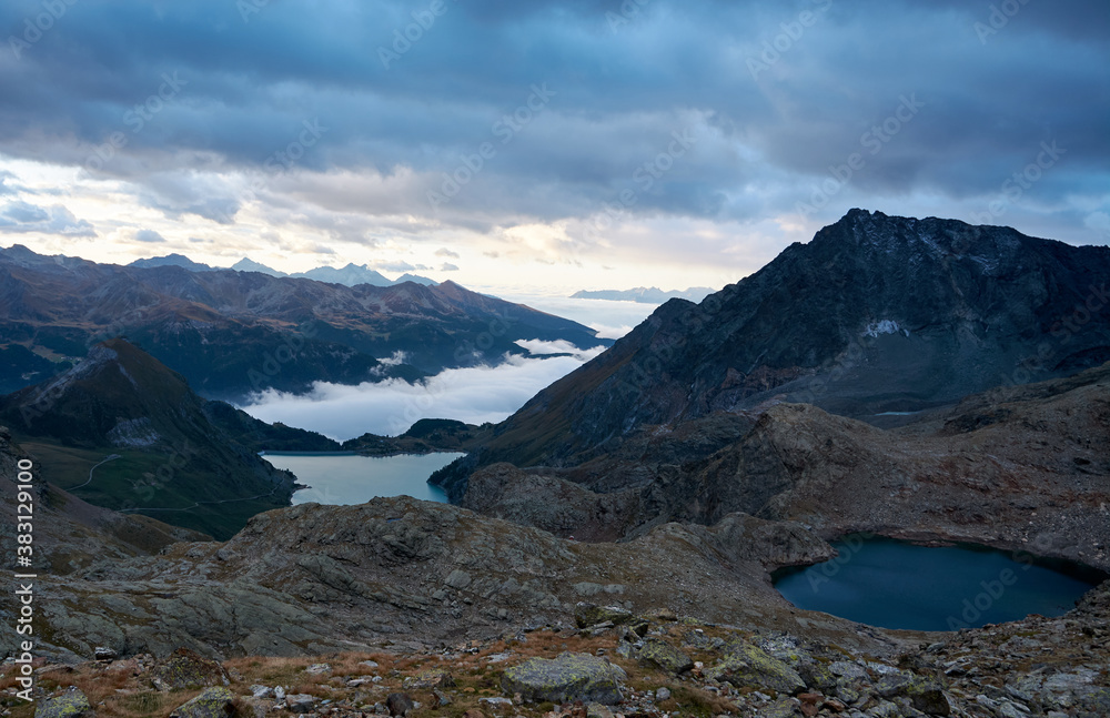 alpine lakes at dawn against the background of mountains with dark clouds