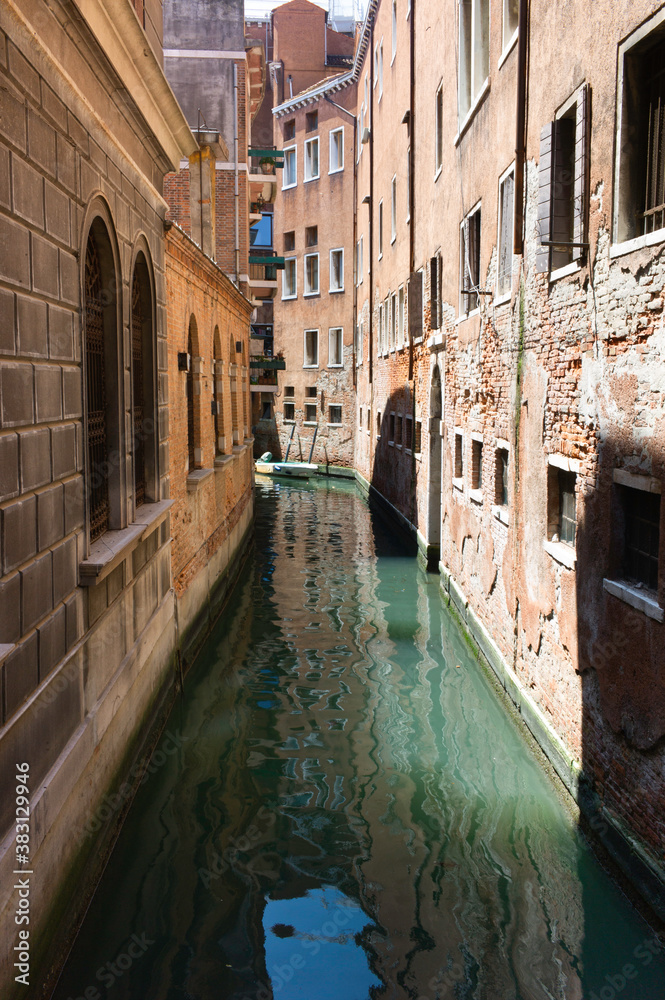 Traditional Venice Cityscape with narrow canal. Vertical image