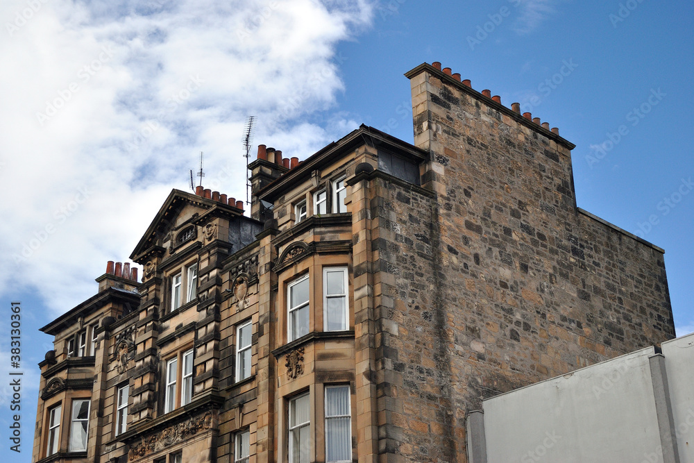 19th Century Stone Tenement Building seen from Below against Blue Sky 19th Century Stone Tenement Building seen from Below against Blue Sky