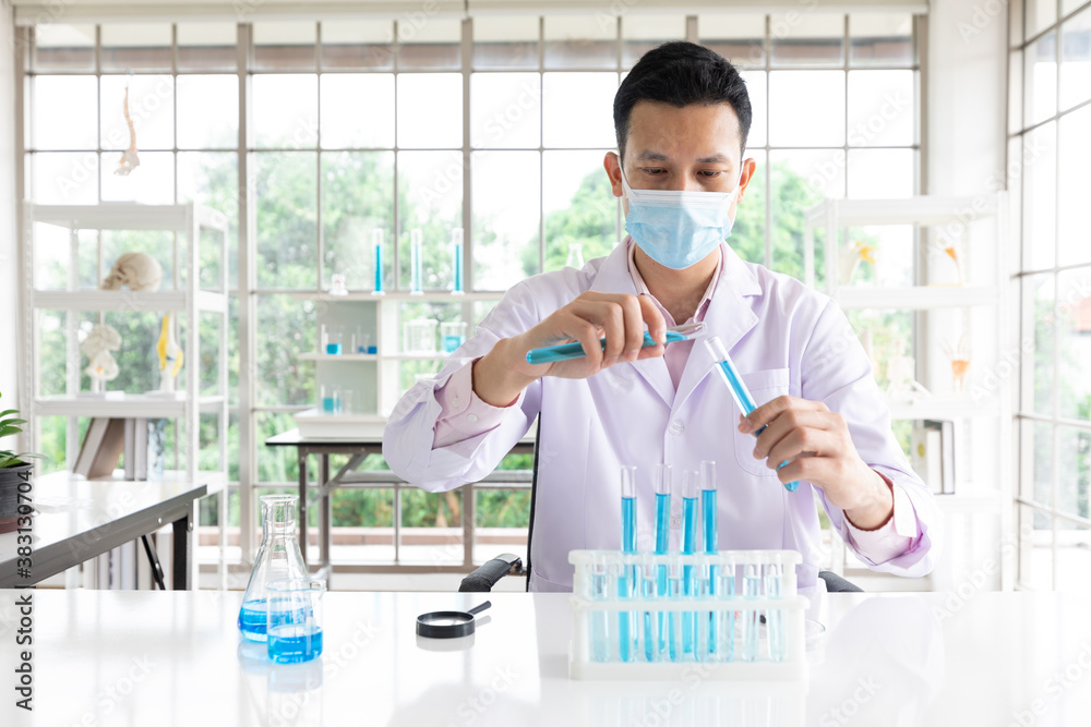 scientist man wearing medical face mask doing or testing a chemical experiment in laboratory scientist man wearing medical face mask doing or testing a chemical experiment in laboratory