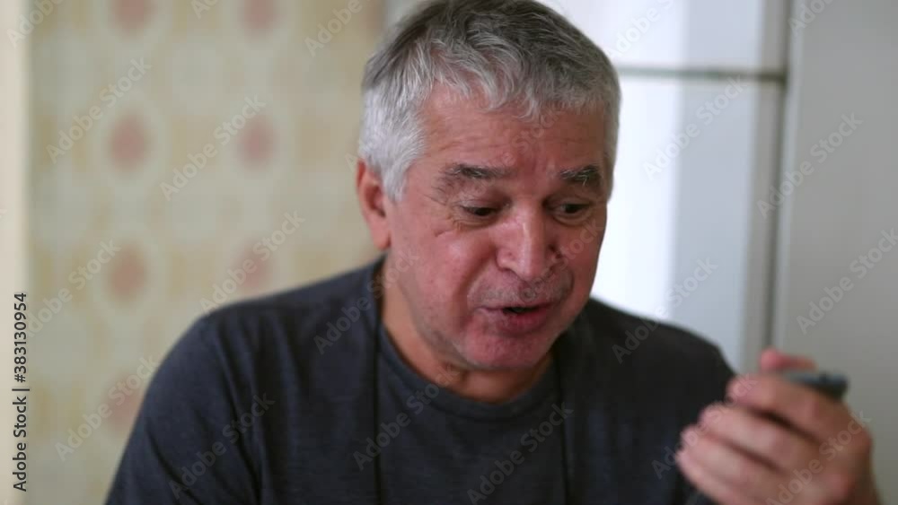 Happy casual older man receiving good news on mobile phone Happy casual older man receiving good news on mobile phone