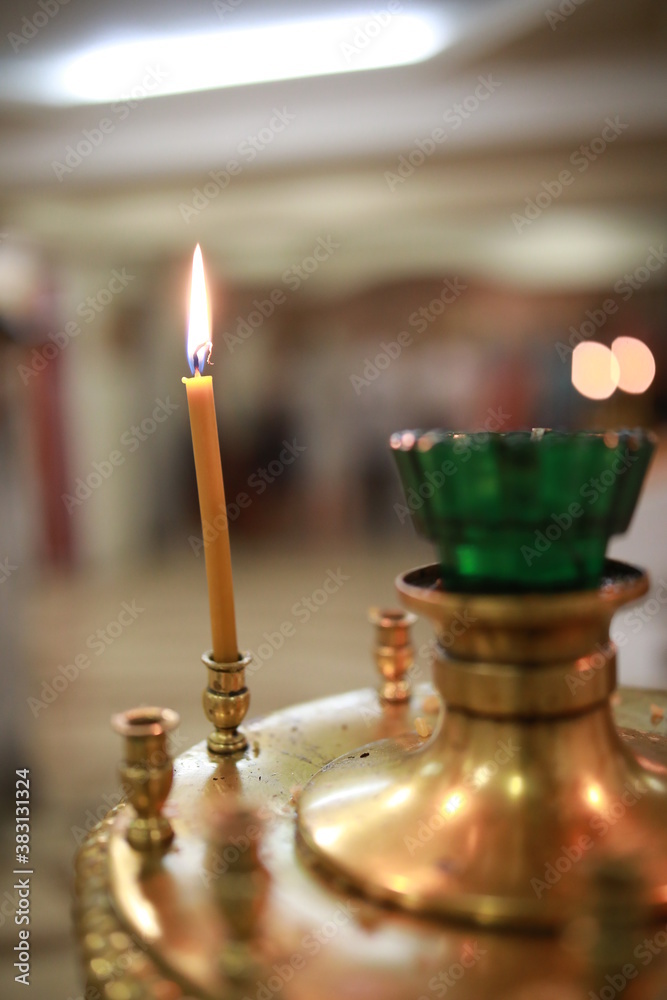 burning candle in a candlestick burning candle in a candlestick