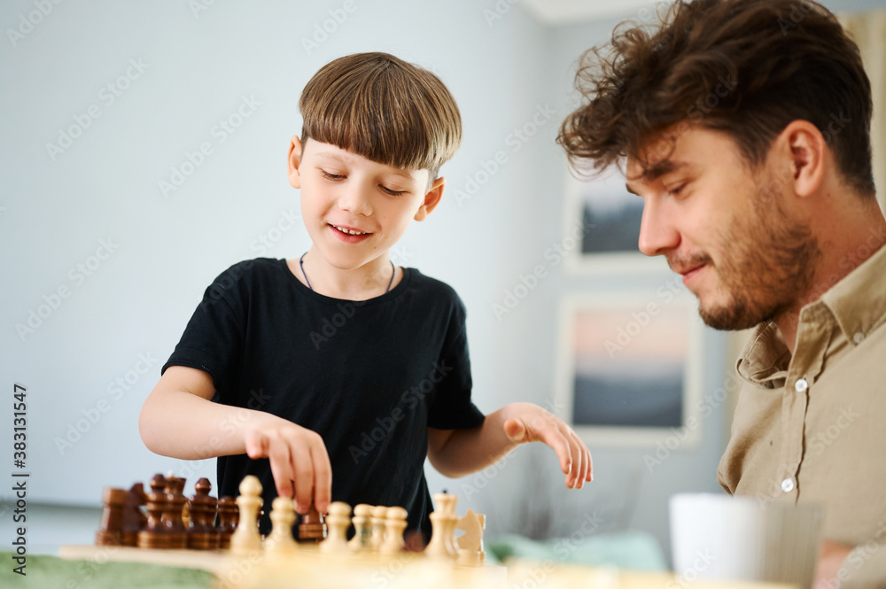 Father teaching son how to play chess. Concept of education and teaching. Father teaching son how to play chess. Concept of education and teaching.