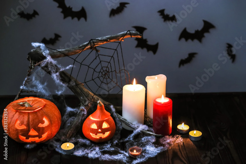 Halloween pumpkins with candles, cobwebs, bats. Layout of a Halloween poster. Halloween decor with pumpkins and burning candles photo