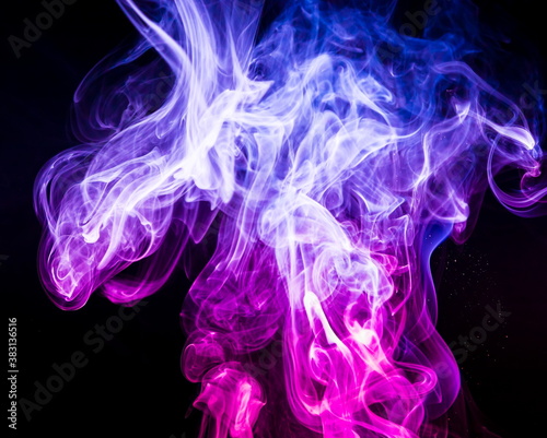Colored smoke on black background © yauhenka