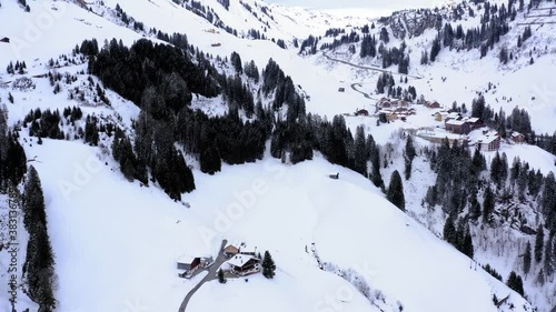 Vallay view with huts. winter mountain landscape view with snow and trees. rural area with on a sunny winter day