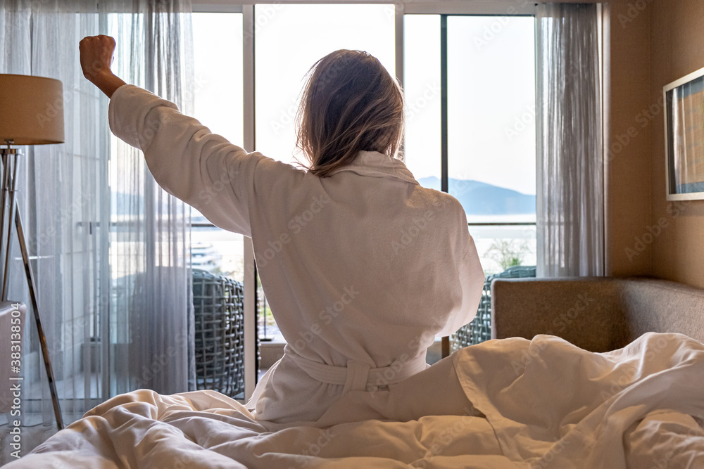 custom made wallpaper toronto digitalback view of woman in bathrobe sitting on bed morning looking out the window and resting hotel room with sea view