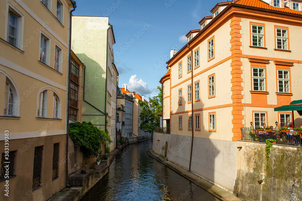 The architecture of the strago city of Prague. River channel in the city. Streets of old Europe, cityscape
