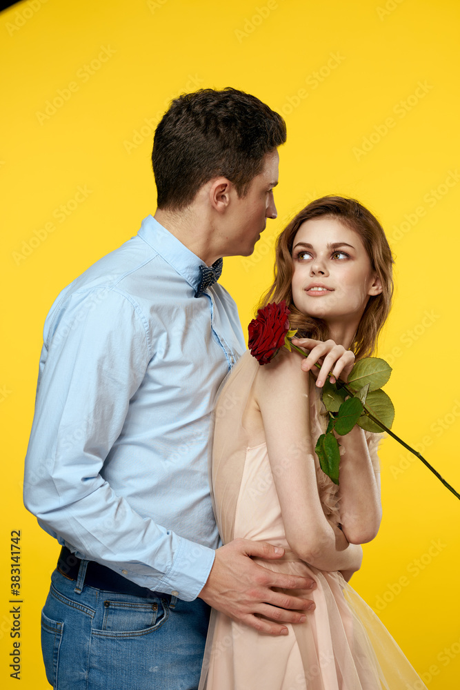 Enamored man and woman with red rose on yellow background cropped view close-up romance Enamored man and woman with red rose on yellow background cropped view close-up romance