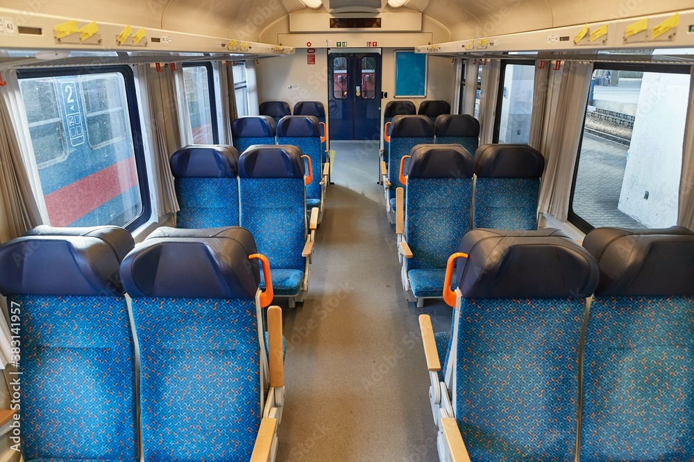 Interior of a passenger train with empty seats, no people during quarantine lockdowns