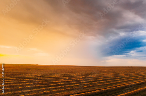 Aerial View Of Sunset Sunrise Bright Sky Above Summer Hay Field Landscape In Evening