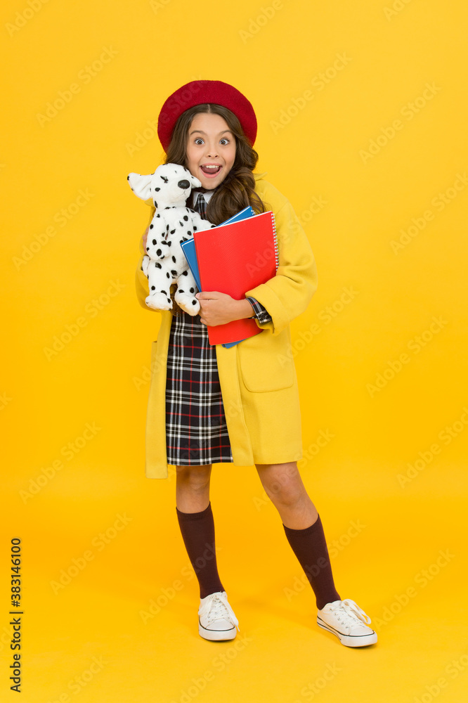 education concept. childhood happiness. school and fashion. child in pupil uniform. kid in french beret on yellow background. stylish teen college student. little girl with toy dog and notebooks education concept. childhood happiness. school and fashion. child in pupil uniform. kid in french beret on yellow background. stylish teen college student. little girl with toy dog and notebooks