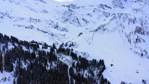 Snowy valley in the austrian alps. Iced rocks and sky view in a winter rural areal. DJI drone view