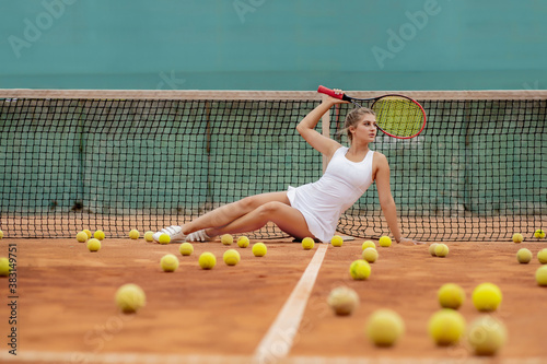 professional tennis player woman with racket and ball near net on court © volody10
