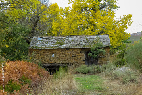 Old mill house  made entirely of stone  with lots of vegetation around  small village of Quintanilla  province of Zamora  autonomous community of Castile and Leon  Spain