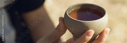 Panel kuchenny z motywem Ceramic bowls made of clay on a wooden background. .The girl is drinking Chinese tea.
