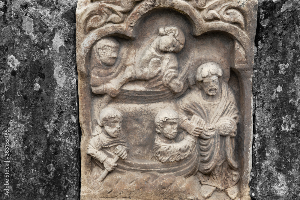Stone carving depicting Christ and the apostles.  With colour toning and selective colour