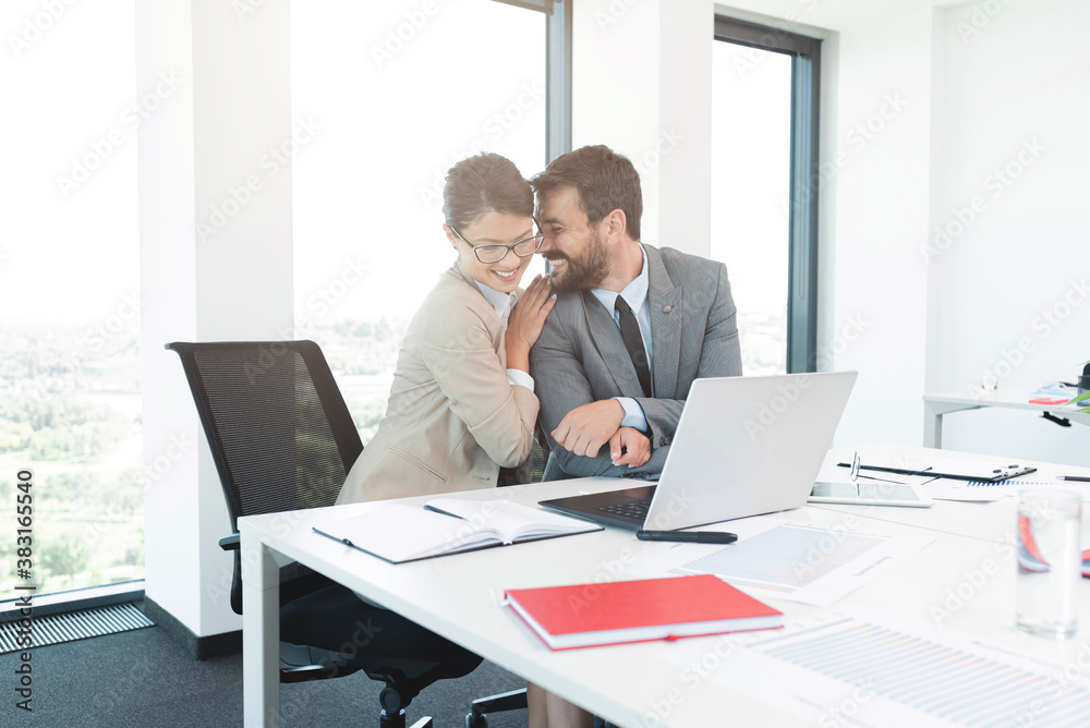 Businessman romancing with pretty secretary at office Businessman romancing with pretty secretary at office