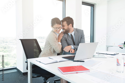 Businessman romancing with pretty secretary at office