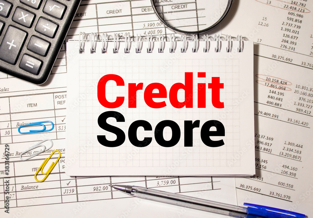 CREDIT SCORE CONCEPT ON NOTEBOOK WITH BLUE BACKGROUND CREDIT SCORE CONCEPT ON NOTEBOOK WITH BLUE BACKGROUND