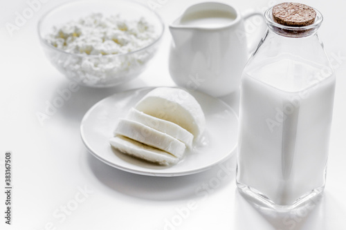 Healthy food concept with milk and cottage cheese on white table