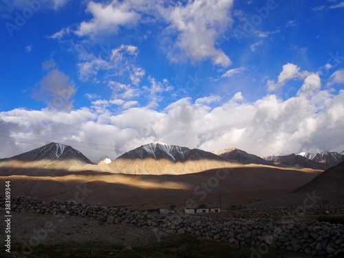 Beautiful blue skies and clouds  and a city darkened by shadows  Pangong tso  Lake   Durbuk  Leh  Ladakh  Jammu and Kashmir  India