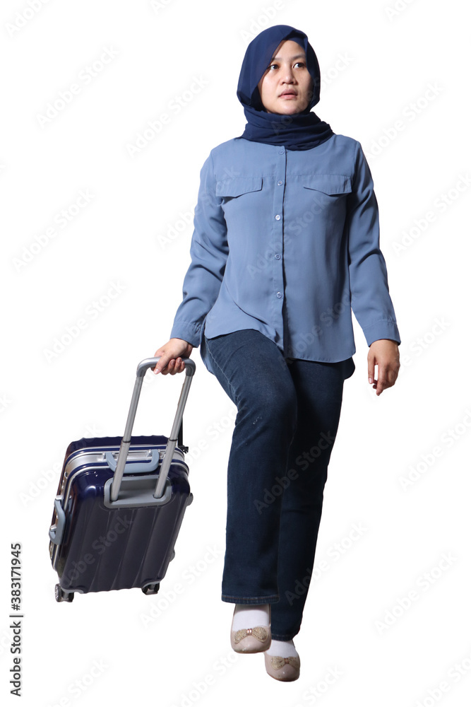 Asian muslim woman traveler walking forward drag his suitcase luggage, low angle full length portrait Asian muslim woman traveler walking forward drag his suitcase luggage, low angle full length portrait