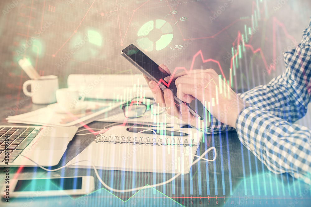 Fototapeta premium Double exposure of man's hands holding and using a digital device and forex graph drawing. Financial market concept.