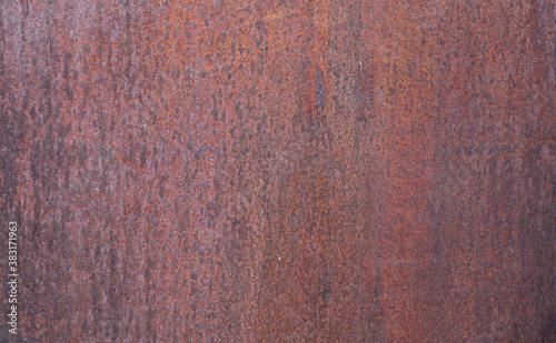 rusty metal background...Rusty metal background of dark brown color with signs of corrosion, close-up side view.