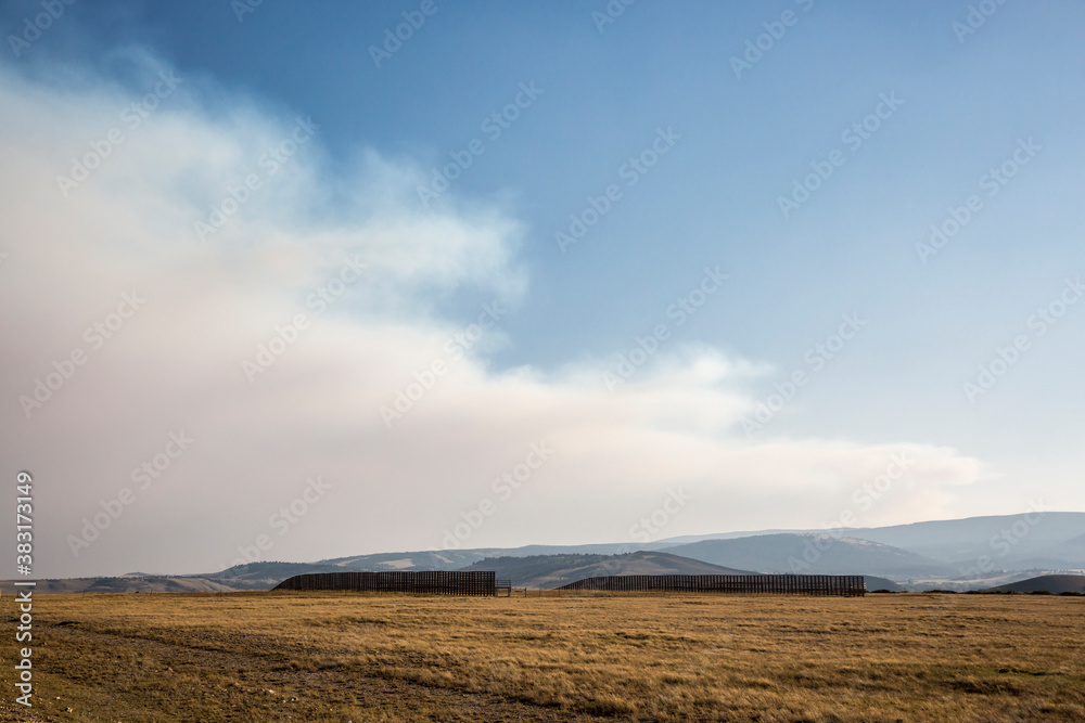 Landscape view of the forest fire smoke growing over the plains of Wyoming