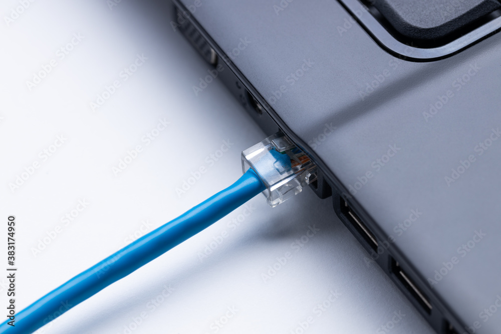 person plugging internet ethernet cable to laptop pc. online and network access conceptual. internet connection problem conceptual person plugging internet ethernet cable to laptop pc. online and network access conceptual. internet connection problem conceptual