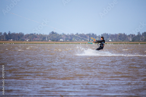 man practicing kitesurfing in a lagoon