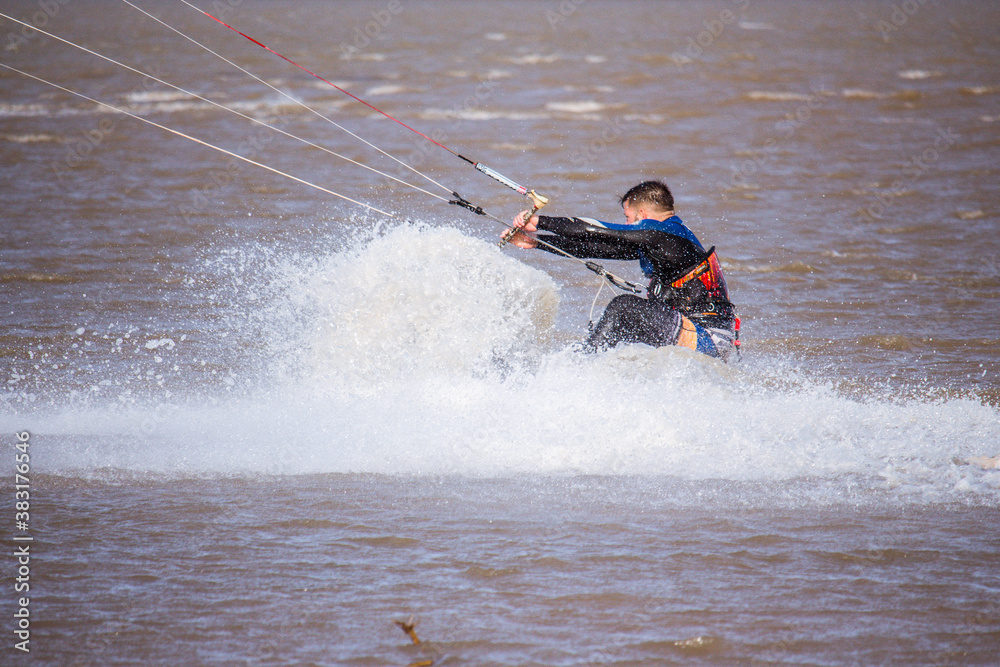 man splashed with water practicing kitesurfing man splashed with water practicing kitesurfing