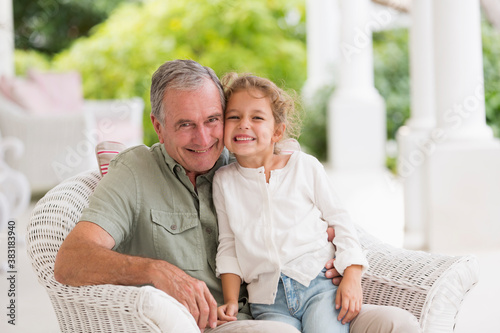 Canvastavla Portrait happy grandfather and granddaughter on patio