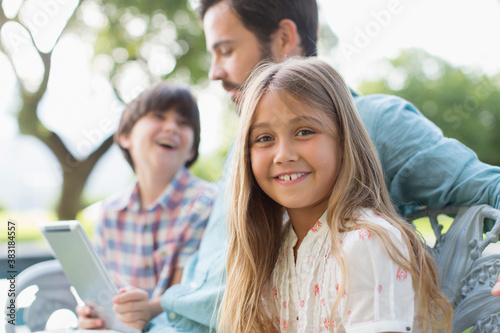 Принти на полотні Portrait happy girl with father and brother on bench