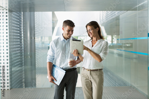 Corporate business people using digital tablet in modern office